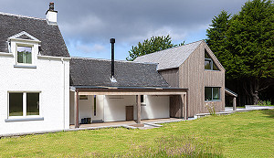 Rear of architect designed extension to crofthouse with veranda
