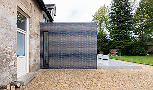 Staffordshire blue brick extension with elegant slot window in Bearsden